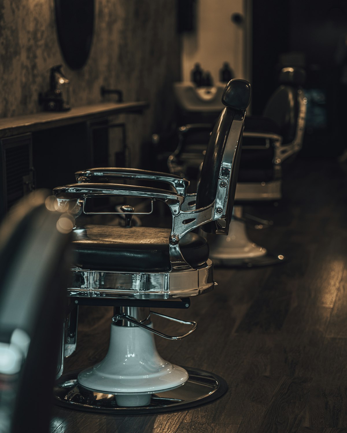 A barber finishing a fade at the first chair
